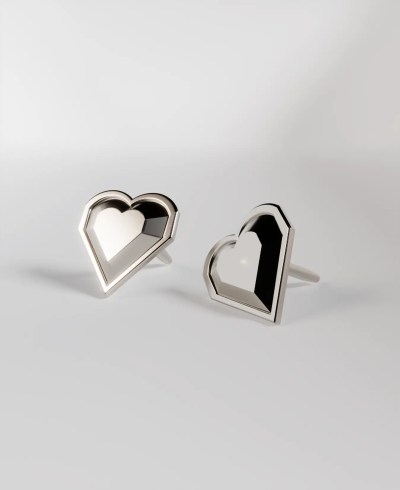 Pair of 18k white gold stud earrings, featuring a faceted, geometric heart shape.