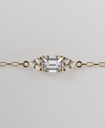 18k yellow gold chain bracelet featuring a horizontal pendant emerald cut clear diamond, with round clear diamonds 3 at the top and three at the bottom, on a delicate gold chain band.